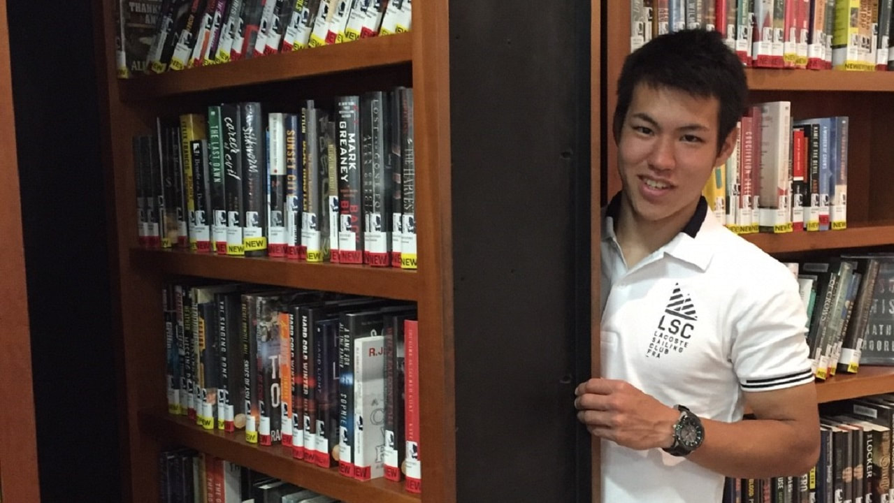 student by bookshelf